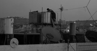 Rooftop water storage — a common sight across Palestinian communities